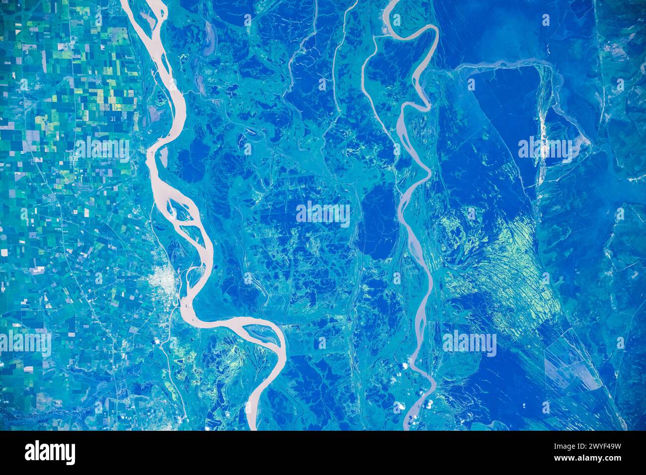 Green-covered land and rivers in the area of Argentina and Uruguay. Digital enhancement of an image furnished by NASA Stock Photo
