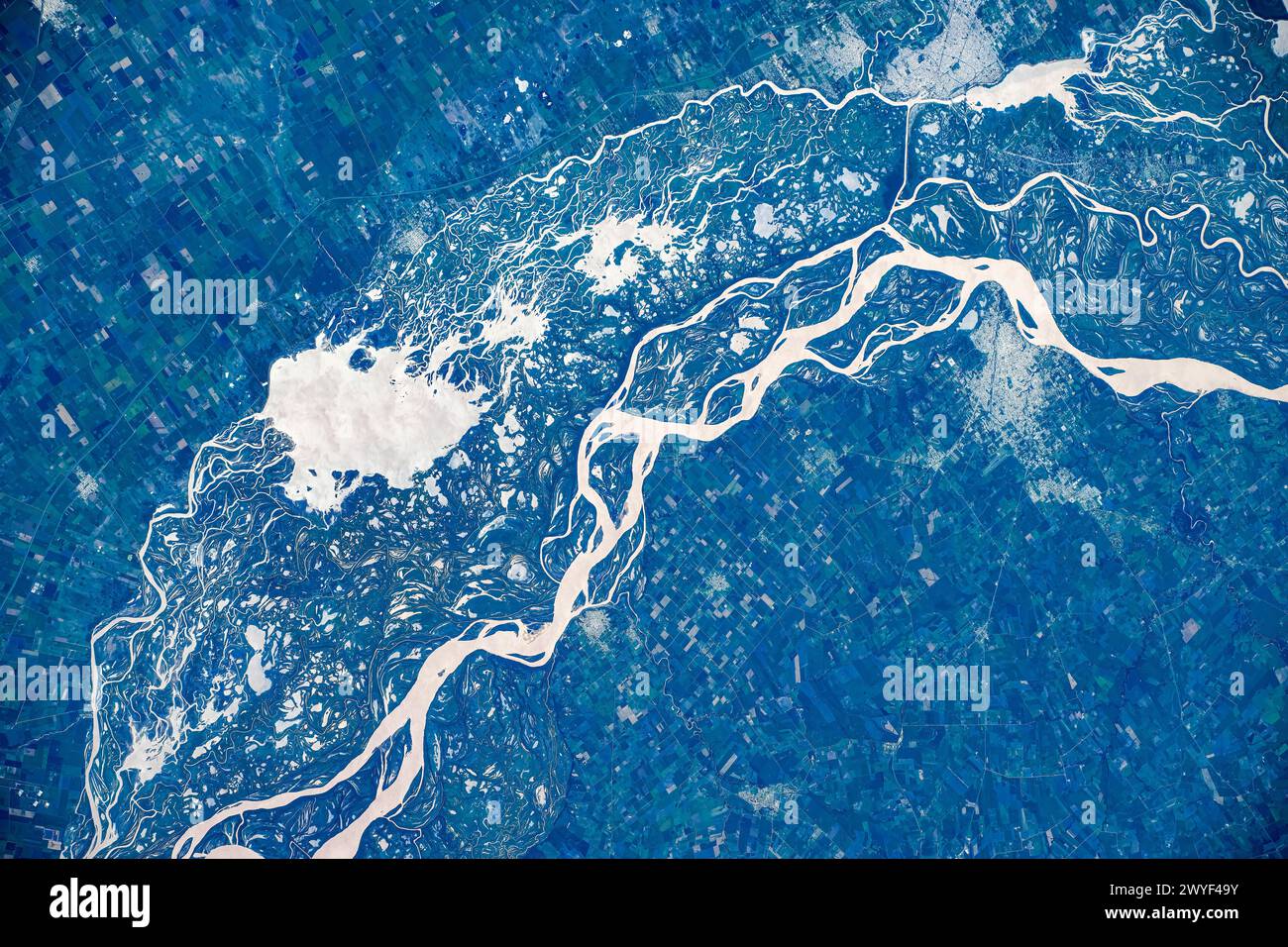 Green-covered land and rivers in the area of Argentina and Uruguay. Digital enhancement of an image furnished by NASA Stock Photo