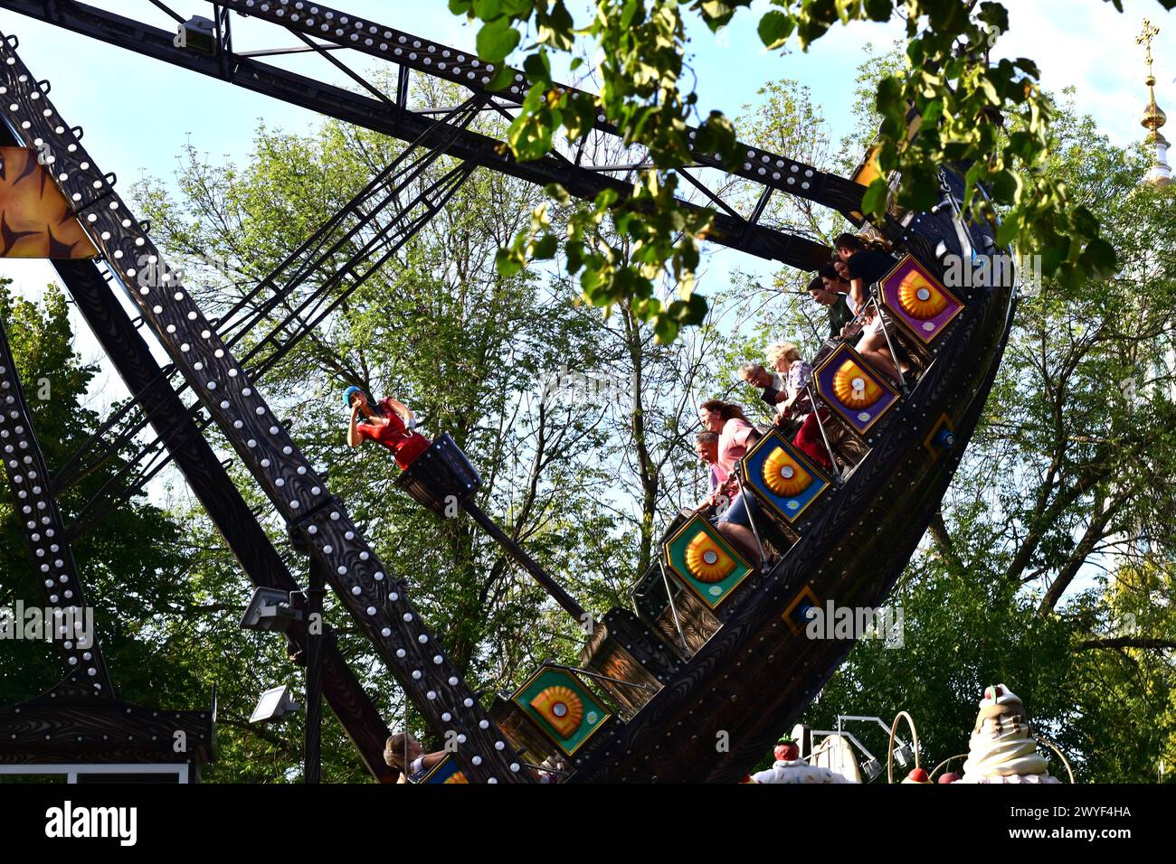 People Ride One Of The Rides In The Park Stock Photo - Alamy