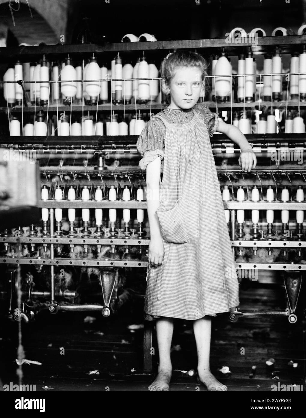 Addie Card, 12 years. Spinner in North Pormal (i.e., Pownal) Cotton Mill. Vt. Girls in mill say she is ten years. She admitted to me she was twelve; that she started during school vacation and new would 'stay. North Pownal, Vermont. Stock Photo