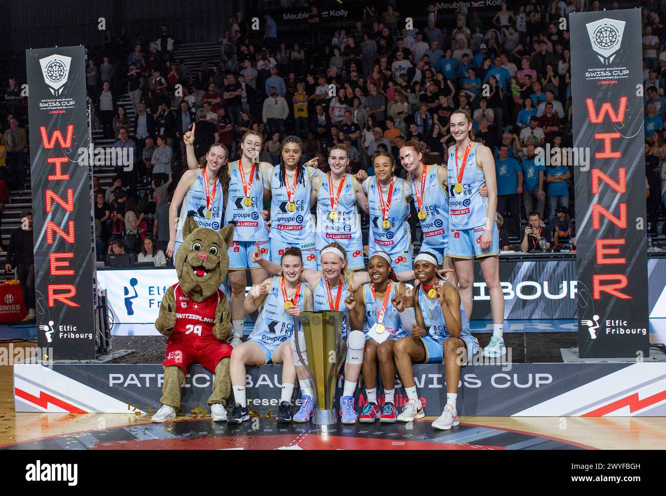 Fribourg, Fribourg, Switzerland. 6th Apr, 2024. Fribourg Switzerland, 04/06/2024: BCF Elfic Fribourg team celebrates her victory during ceremony awards during Patrick Baumann Swiss Cup. Patrick Baumann Swiss Cup took place at Saint-Leonard hall in Fribourg.BCF Elfic Fribourg wins 78-61. (Credit Image: © Eric Dubost/ZUMA Press Wire) EDITORIAL USAGE ONLY! Not for Commercial USAGE! Credit: ZUMA Press, Inc./Alamy Live News Stock Photo