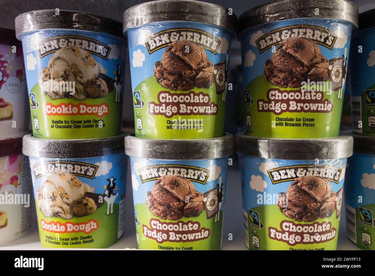Closeup of Ben & Jerry's Chocolate Fudge Brownie and Cookie Dough ice cream tubs in a supermarket freezer. Unilever Stock Photo