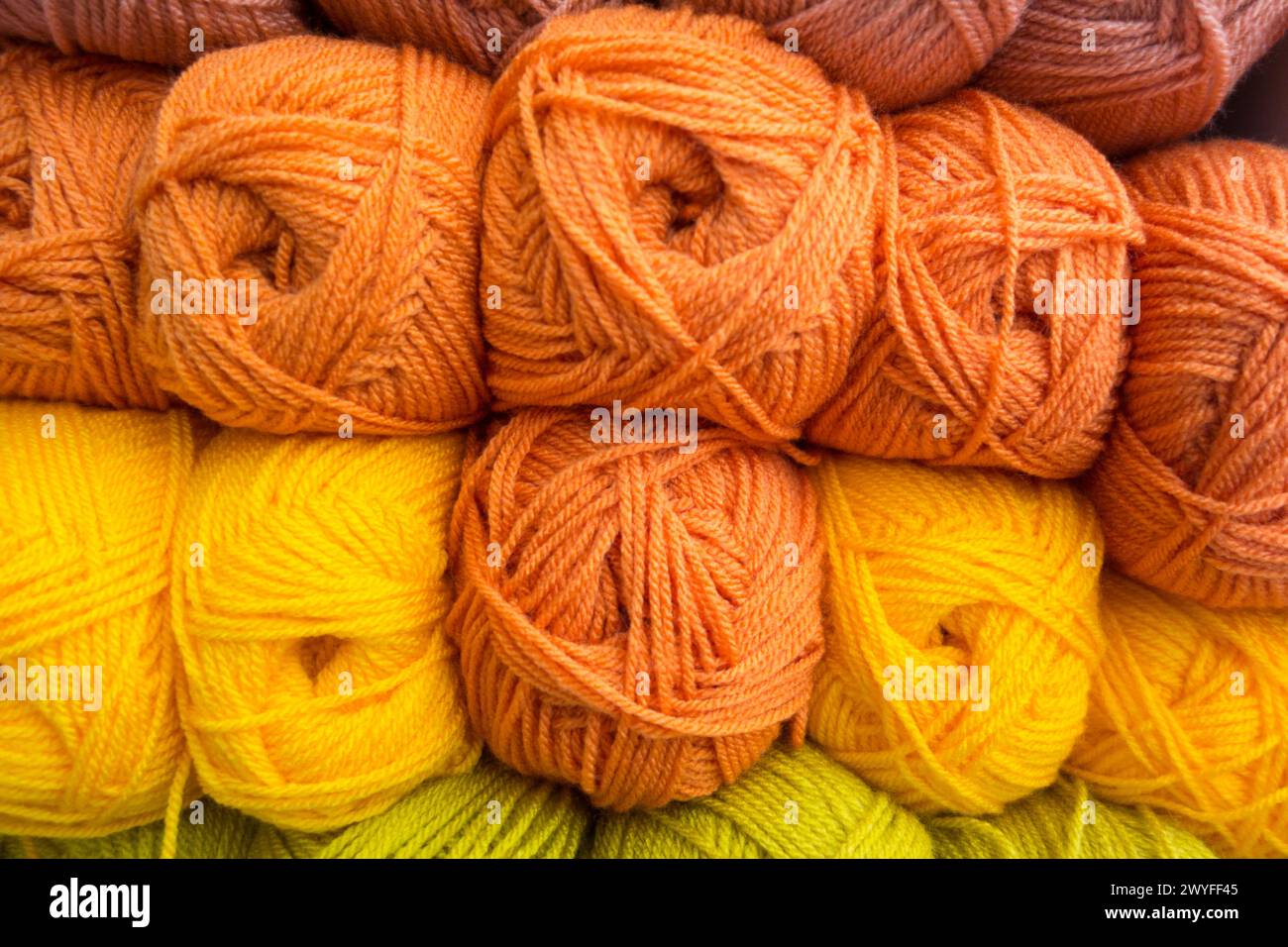 Close-up of yellow and orange colourful balls of wool Stock Photo
