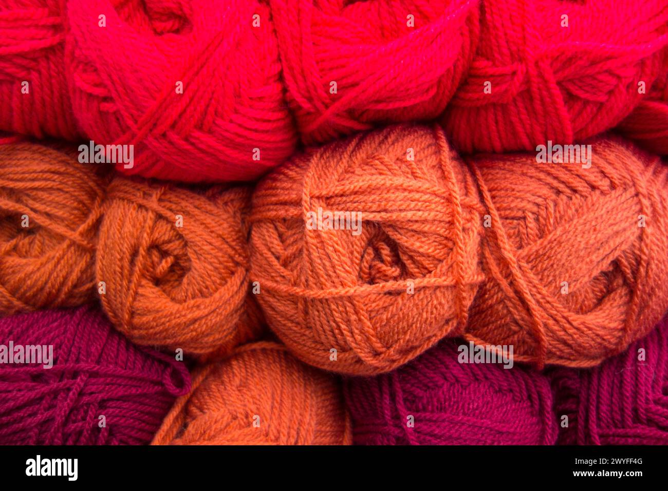 Close-up of colourful orange, red and purple balls of wool Stock Photo