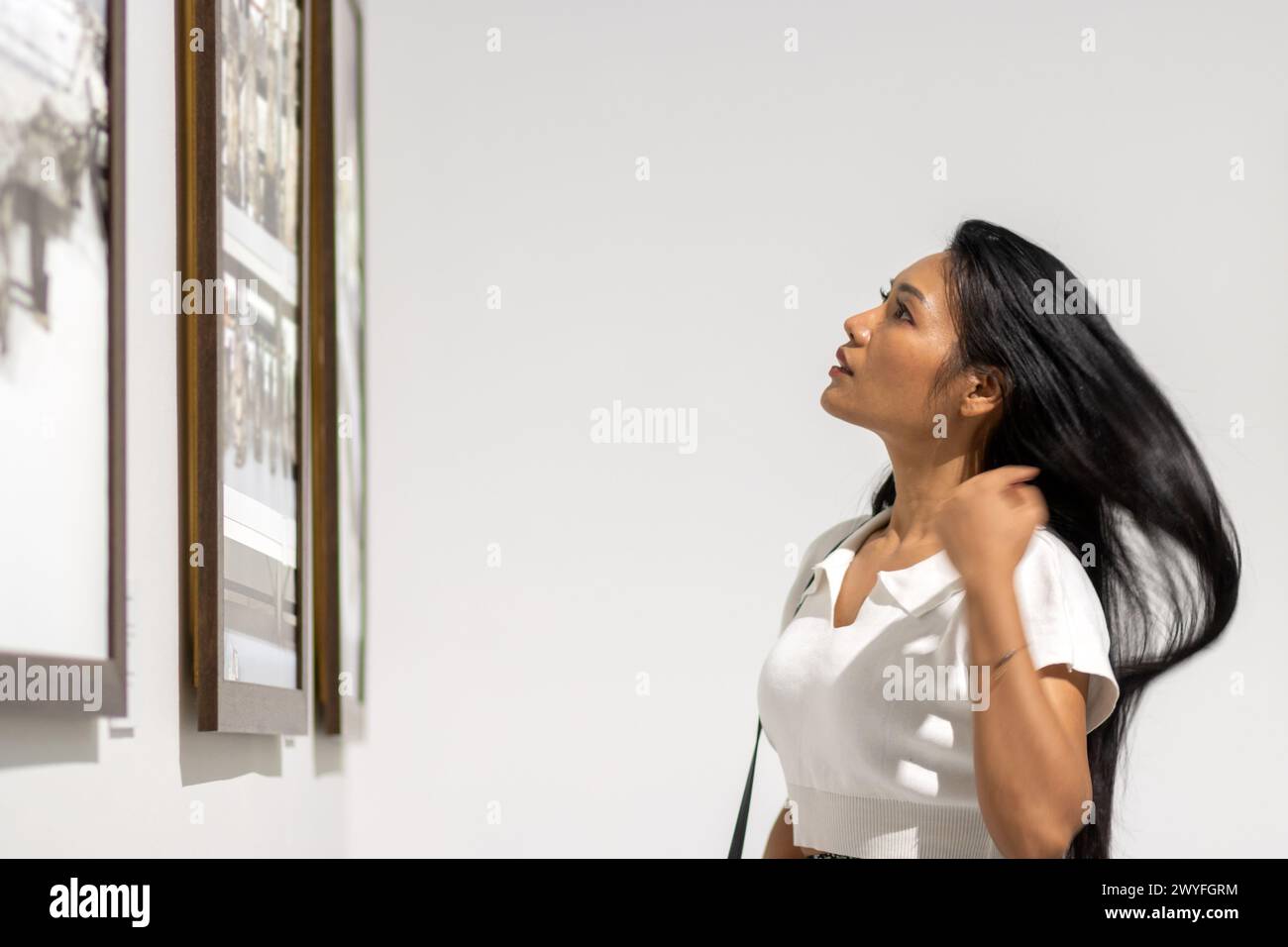 A young woman visited an exhibition of paintings and photographs Stock ...