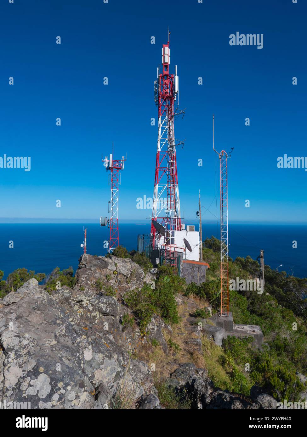 Telecommunication tower with antennas and blue sky background at Pico do Facho hill viewpoint, Machico, Madeira, Portugal Stock Photo