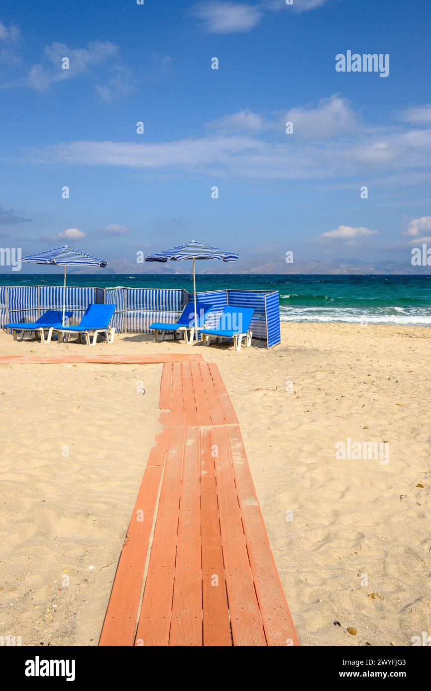 Sunbeds with umbrella on sandy beach of Marmari. The Greek island of Kos Stock Photo