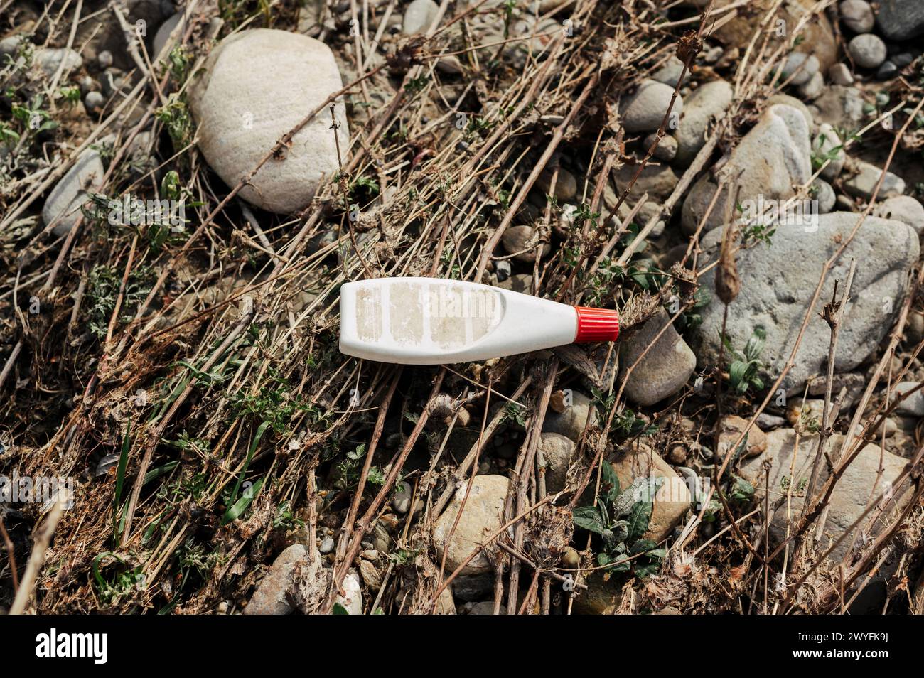 Plastic pollution along the banks of a river in the Po Valley (Cuneo, Piedmont, Italy) Stock Photo