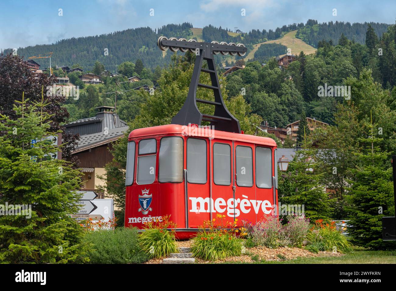 An old red cabin of the Rochebrune cable car on display on a public garden of the popular alpine ski resort in summer, Megeve, Haute Savoie, France Stock Photo