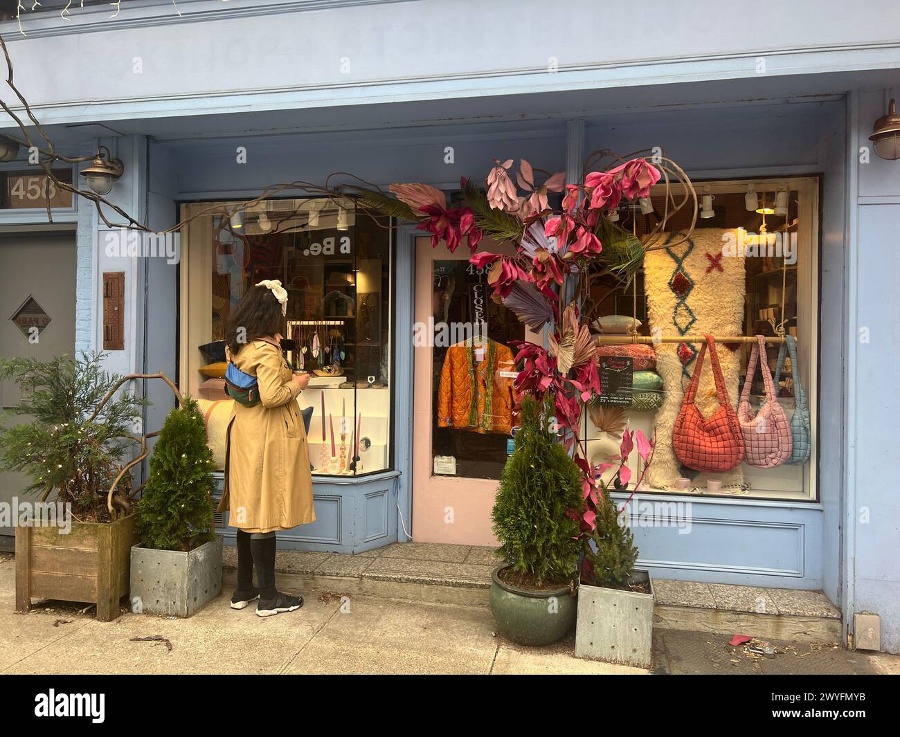 Woman looks into the window of a women's clothing and gift shop in Brooklyn, New York. Stock Photo