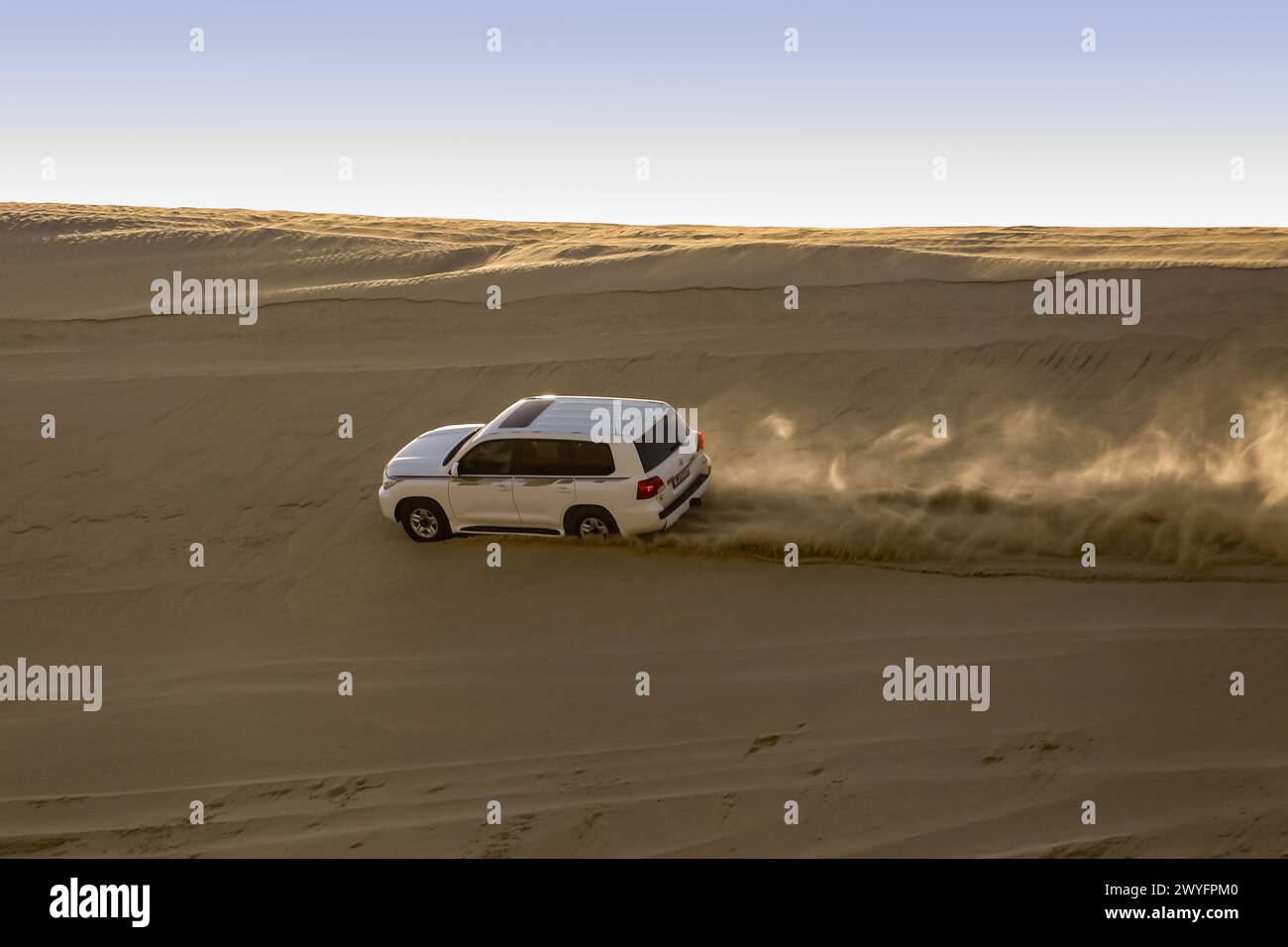 Desert safari in desert off Arabian, Group of tourists make a safari with 4wd cars in the desert dunes. Stock Photo