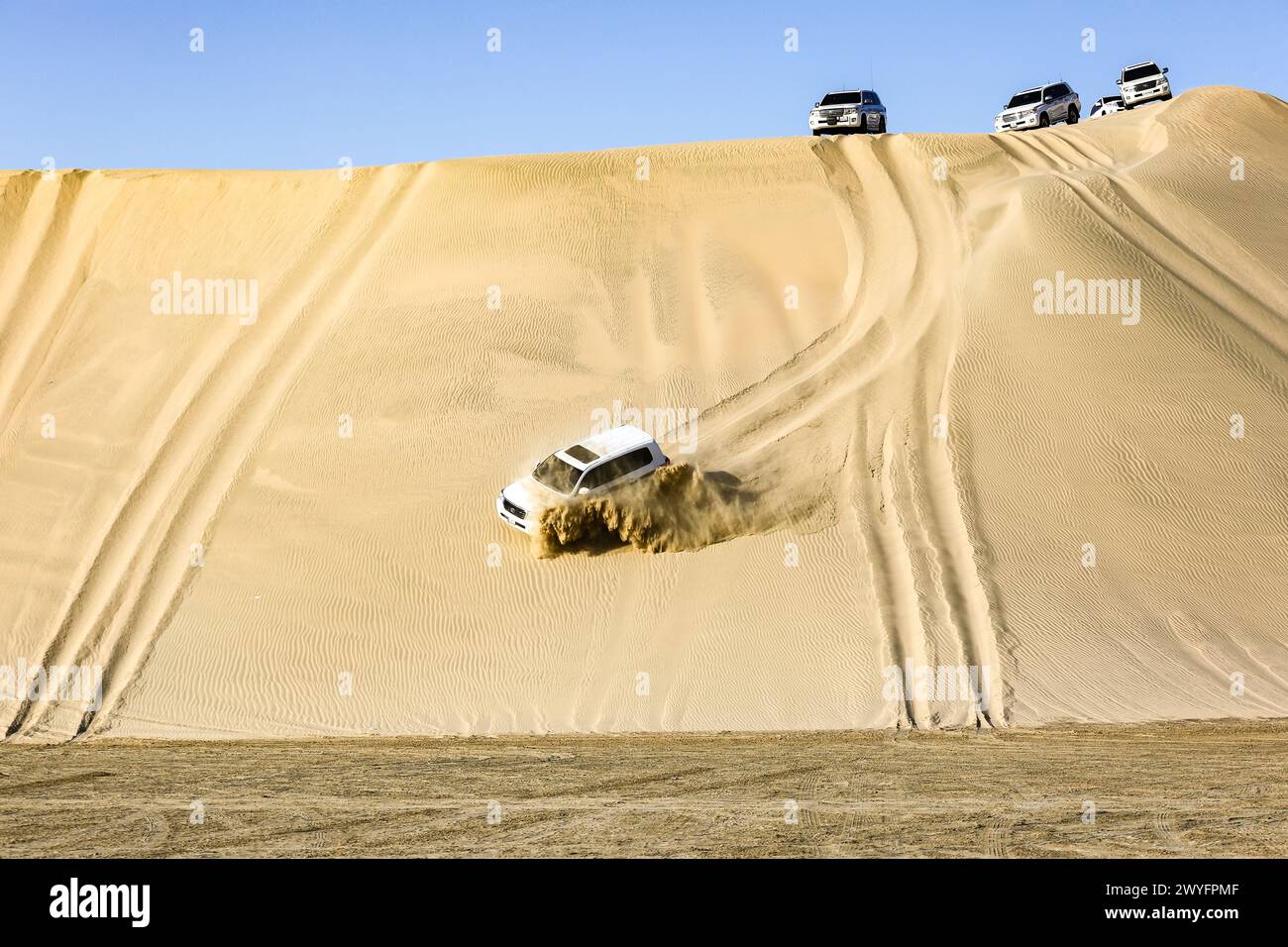 Cars being driven through inland sea desert, Driving their 4x4 cars to desert. during weekends is enjoyed by many. Stock Photo