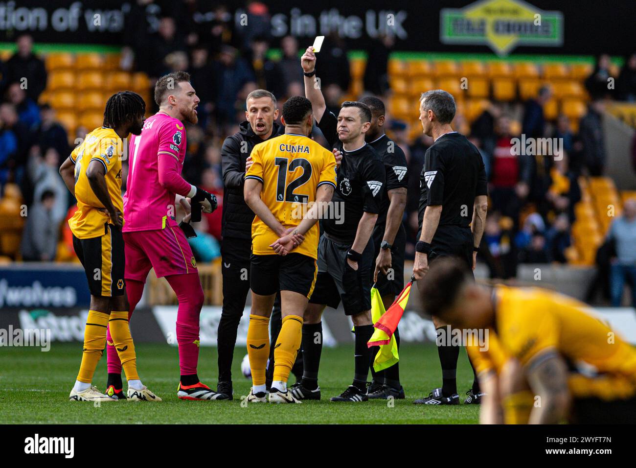 6th April 2024;  Molineux Stadium, Wolverhampton, West Midlands, England; Premier League Football, Wolverhampton Wanderers versus West Ham United; Referee Tony Harrington issues a yellow card to Matheus Cunha of Wolves for dissent after the final whistle Stock Photo