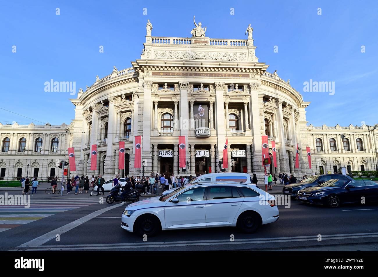 Vienna, Austria. 06th Apr, 2024. The Vorarlberg artist and musician Wolfgang Flatz adapted Hitler's Pearl Speech from 1938 for an action in and in front of the Burgtheater in Vienna. Instead of the swastika, there is a dog's head in the middle of the red flags. Credit: Franz Perc/Alamy Live News Stock Photo