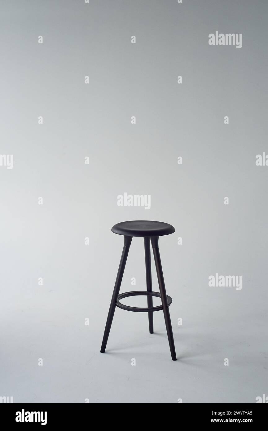 Black high chair on white background. Minimalism in design and life. Stock Photo