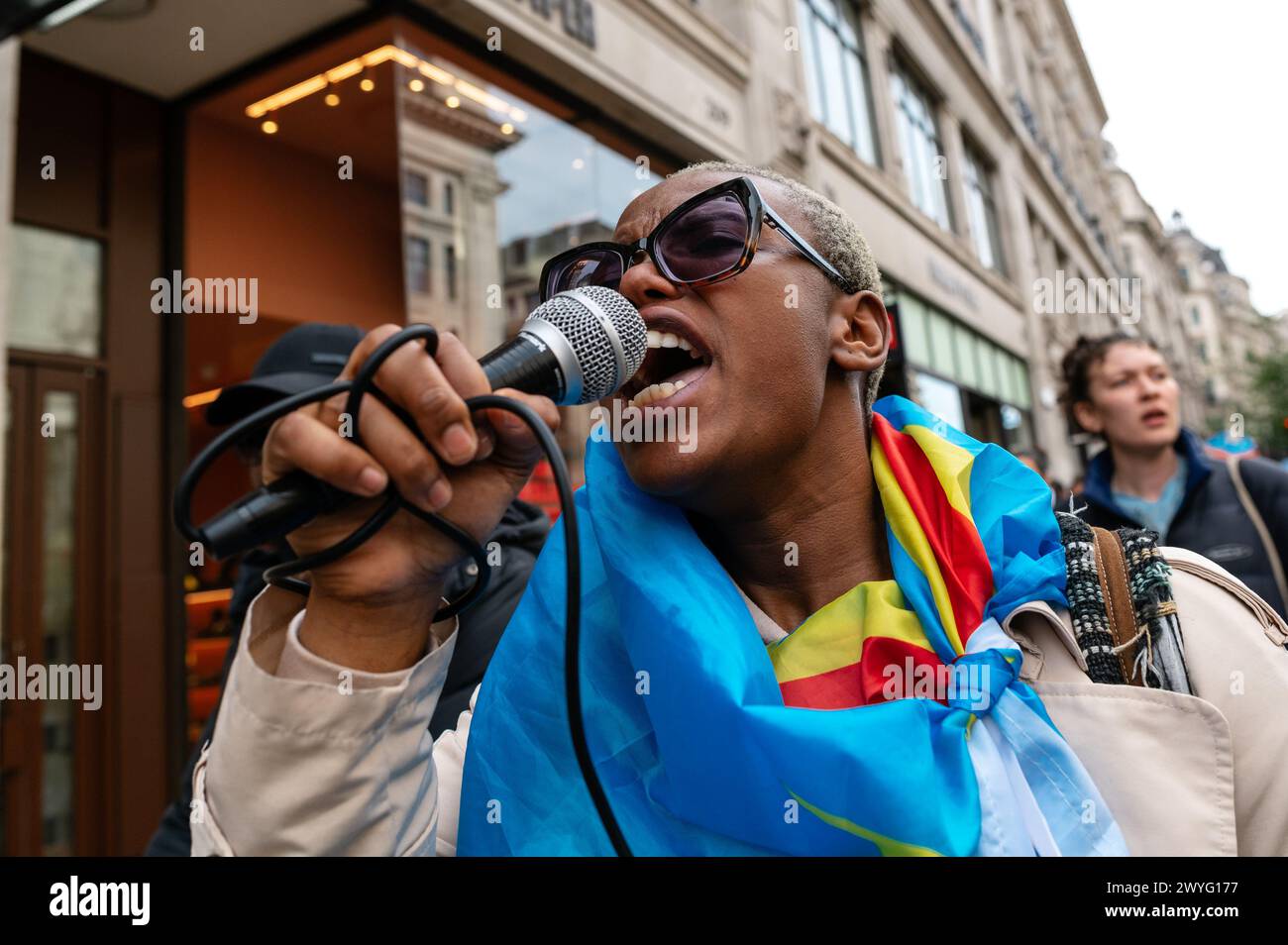 London, UK. 6 April 2024. Protest in support of women harmed, raped and killed in Democratic Republic of Congo. Protesters march toward Downing Street with a stop outside the Apple Store near Oxford Circus. Apple, Samsung and Microsoft are accused of benefiting from cheap child labour in DRC. Credit: Andrea Domeniconi/Alamy Live News Stock Photo