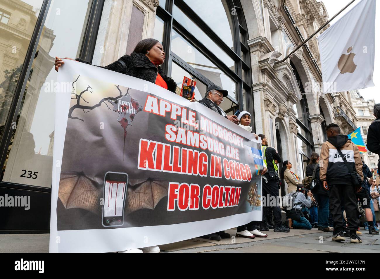 London, UK. 6 April 2024. Protest in support of women harmed, raped and killed in Democratic Republic of Congo. Protesters march toward Downing Street with a stop outside the Apple Store near Oxford Circus. Apple, Samsung and Microsoft are accused of benefiting from cheap child labour in DRC. Credit: Andrea Domeniconi/Alamy Live News Stock Photo