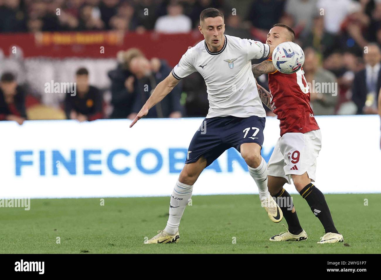 Lazio’s Serbian defender Adam Marusic challenges for the ball with Roma