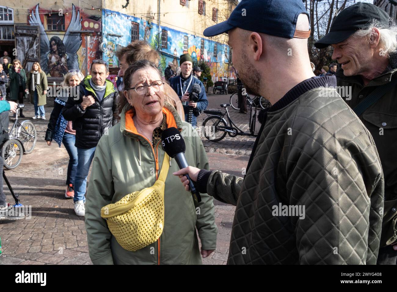 Danish stand-up comedian Morten Wichmann interviews Hulda Mader, Spokesperson for the press group at Christiania, for the TV program Taet pa sandheden during an action day Saturday 6 April 2024. At a meeting at Christiania in March, it was decided that the so-called Pusher Street in the famous Copenhagen neighbourhood should be dug up during a so-called action day 6 April. It is planned that Christianitter aided by workmen will dig up the street. People from outside Christiania are welcome to participate as informed by Christiania s spokesperson. By digging up the street, the Christiania inhab Stock Photo