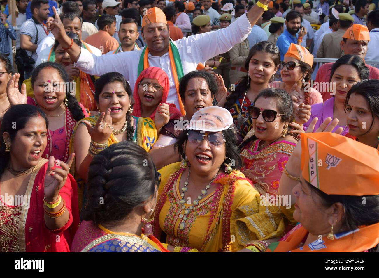 GHAZIABAD, INDIA - APRIL 6: Suuporters of BJP in the Prime Minister's road show on Ghaziabad Ambedkar Road, women workers dancing and singing on April 6, 2024 in Ghaziabad, India. Holding the party symbol 'lotus', PM Modi waved at the cheering crowd who greeted the four leaders with the slogans of 'Abki baar 400 paar' (400-plus seats for NDA this time), 'Har Har Modi' and 'Jai Shri Ram'. BJP first Lok Sabha election roadshow in Uttar Pradesh, canvassing support for the BJP's Ghaziabad candidate Atul Garg, who has been fielded in place of two-time MP and Union minister V K Singh. (Photo by Saki Stock Photo
