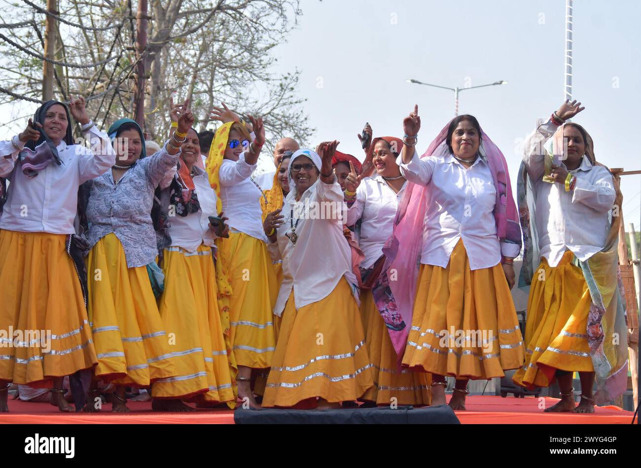 GHAZIABAD, INDIA - APRIL 6: Artists in the Prime Minister's road show on Ghaziabad Ambedkar Road, women workers dancing and singing on April 6, 2024 in Ghaziabad, India. Holding the party symbol 'lotus', PM Modi waved at the cheering crowd who greeted the four leaders with the slogans of 'Abki baar 400 paar' (400-plus seats for NDA this time), 'Har Har Modi' and 'Jai Shri Ram'. BJP first Lok Sabha election roadshow in Uttar Pradesh, canvassing support for the BJP's Ghaziabad candidate Atul Garg, who has been fielded in place of two-time MP and Union minister V K Singh. (Photo by Sakib Ali/Hind Stock Photo