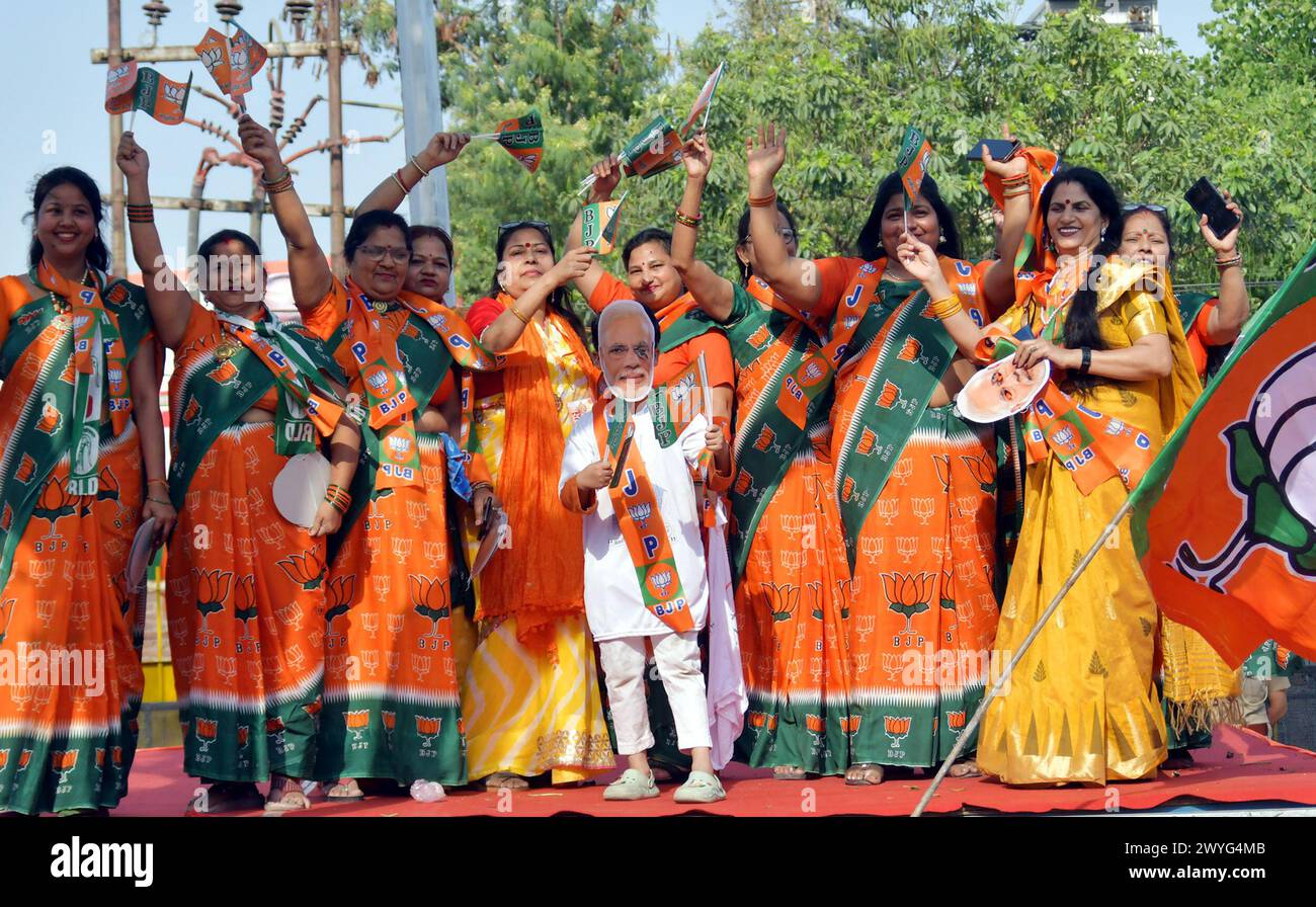 GHAZIABAD, INDIA - APRIL 6: Artists and Suppoorters of BJP in the Prime Minister's road show on Ghaziabad Ambedkar Road, women workers dancing and singing on April 6, 2024 in Ghaziabad, India. Holding the party symbol 'lotus', PM Modi waved at the cheering crowd who greeted the four leaders with the slogans of 'Abki baar 400 paar' (400-plus seats for NDA this time), 'Har Har Modi' and 'Jai Shri Ram'. BJP first Lok Sabha election roadshow in Uttar Pradesh, canvassing support for the BJP's Ghaziabad candidate Atul Garg, who has been fielded in place of two-time MP and Union minister V K Singh. ( Stock Photo