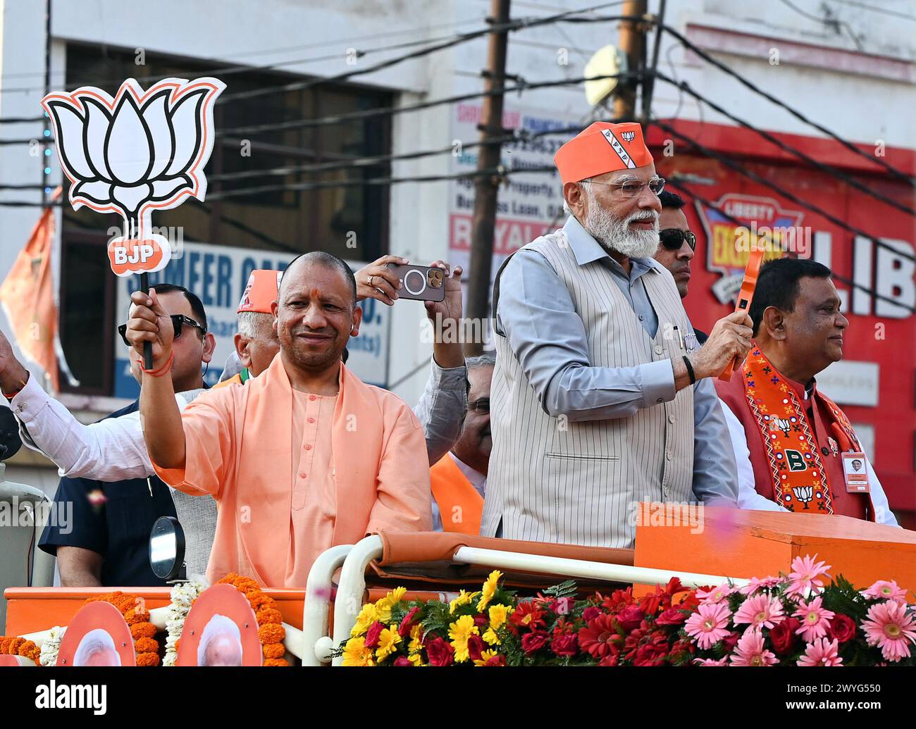 GHAZIABAD, INDIA - APRIL 6: Prime Minister Narendra Modi and Uttar Pradesh CM Yogi Adityanath holding a road show ahead of Lok Sabha Election on April 6, 2024 in Ghaziabad, India. Holding the party symbol 'lotus', PM Modi waved at the cheering crowd who greeted the four leaders with the slogans of 'Abki baar 400 paar' (400-plus seats for NDA this time), 'Har Har Modi' and 'Jai Shri Ram'. BJP first Lok Sabha election roadshow in Uttar Pradesh, canvassing support for the BJP's Ghaziabad candidate Atul Garg, who has been fielded in place of two-time MP and Union minister V K Singh. (Photo by Ajay Stock Photo