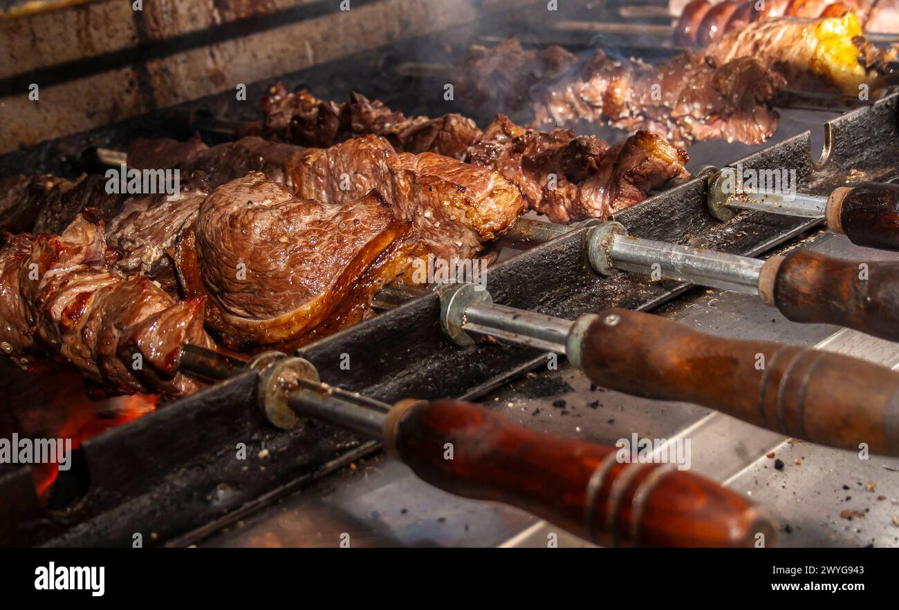 Brazilian style beef ribs Barbecue grill on skewers at a churrascaria ...