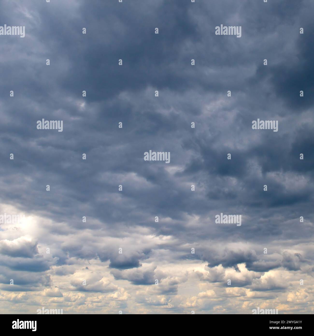 Black storm clouds and bright horizon in sky. Stock Photo