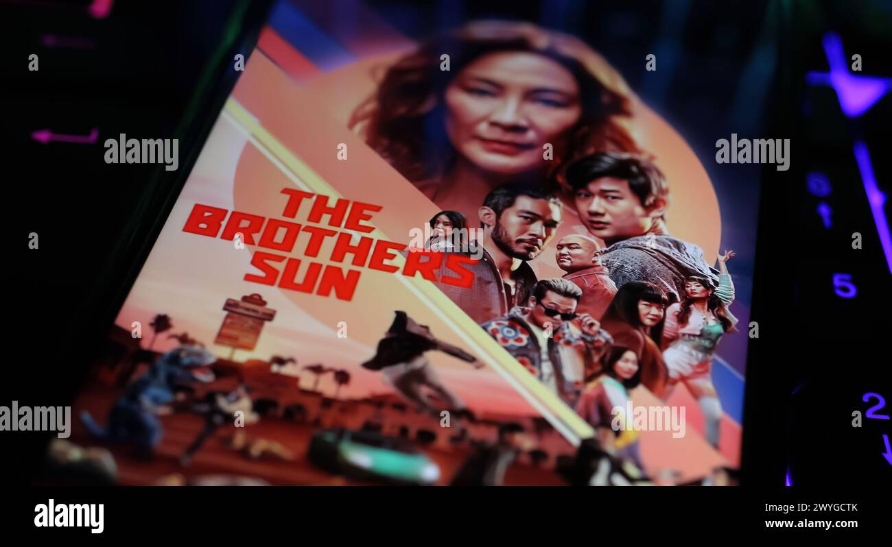 Viersen, Germany - April 3. 2024: Netflix series The Brothers Sun cover poster on smartphone screen on computer keyboard Stock Photo