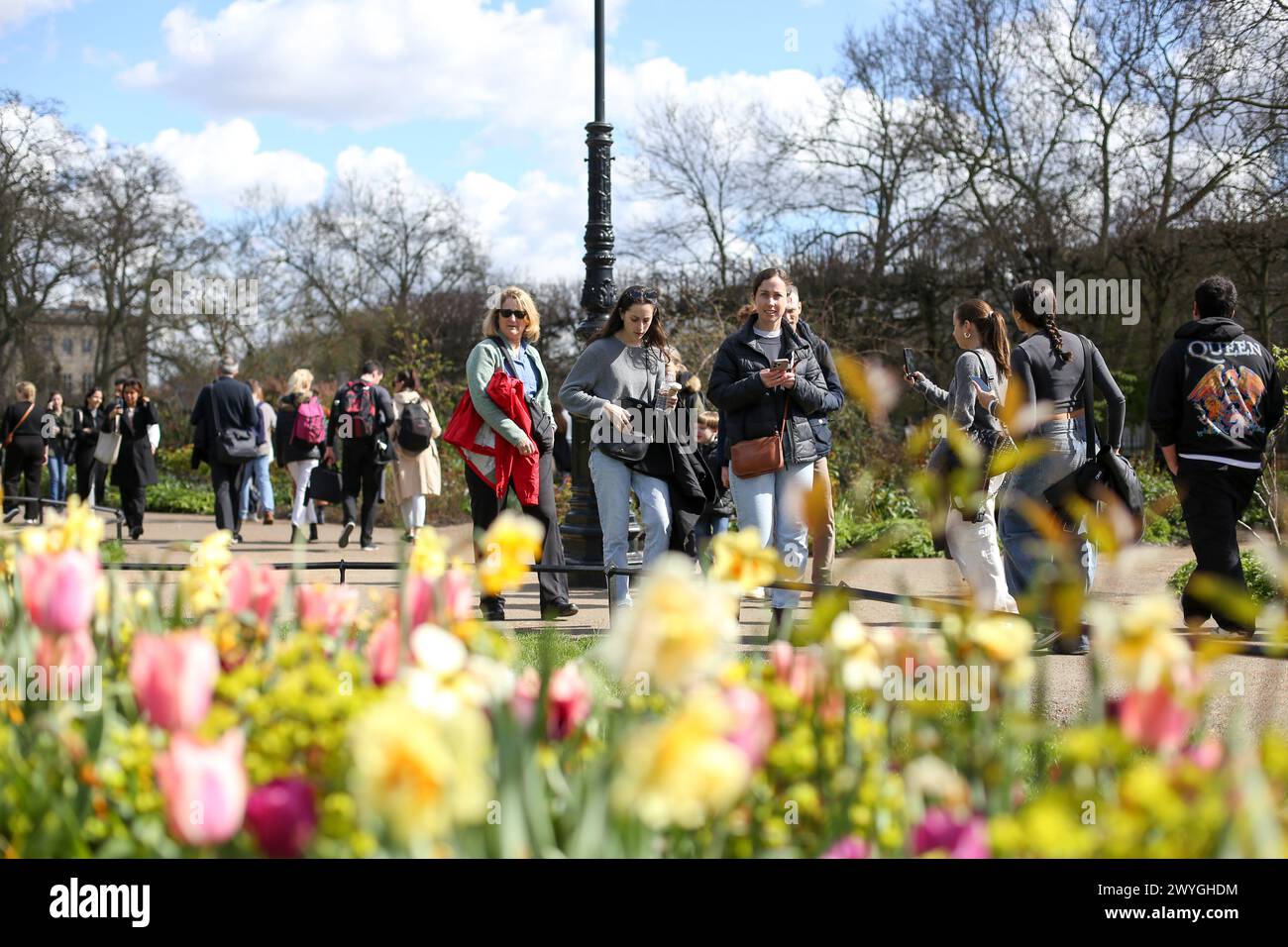 London, UK. 30th Mar, 2024. People walk past spring flowers in Hyde Park in London on a sunny spring day. Weather forecasters are expecting warmer temperature over the next few days. (Credit Image: © Steve Taylor/SOPA Images via ZUMA Press Wire) EDITORIAL USAGE ONLY! Not for Commercial USAGE! Stock Photo