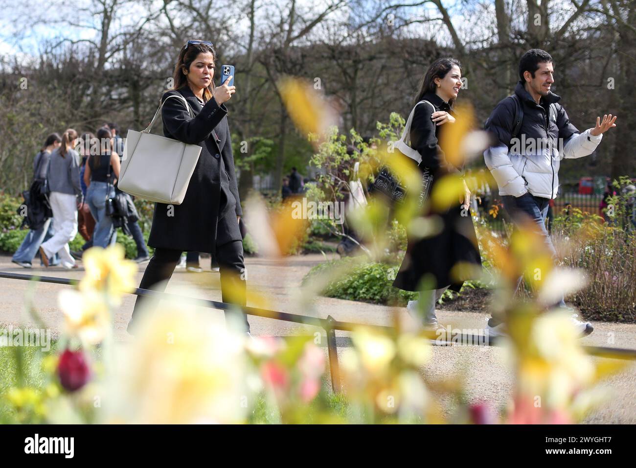 London, UK. 30th Mar, 2024. People walk past spring flowers in Hyde Park in London on a sunny spring day. Weather forecasters are expecting warmer temperature over the next few days. (Photo by Steve Taylor/SOPA Images/Sipa USA) Credit: Sipa USA/Alamy Live News Stock Photo