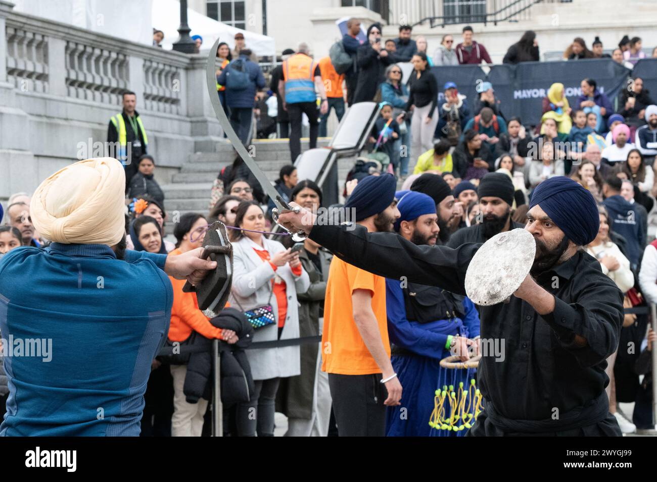 London, UK. 6 April, 2024. Sikh men stage a mock sword fight
