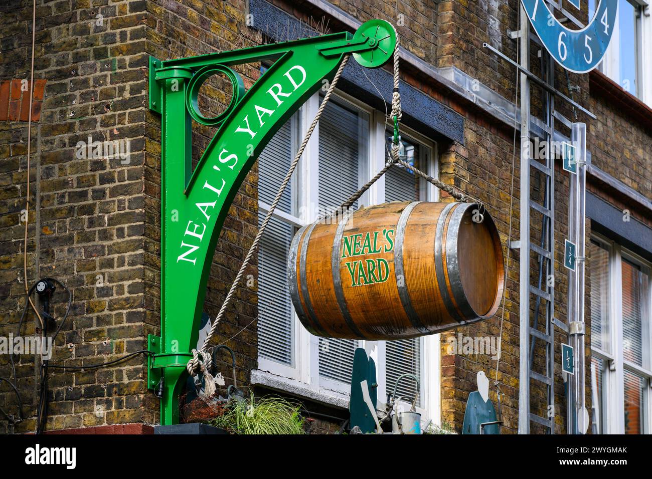 London, UK - March 24, 2024; Sign with hanging barrel and name at Neal's Yard in Central London Stock Photo