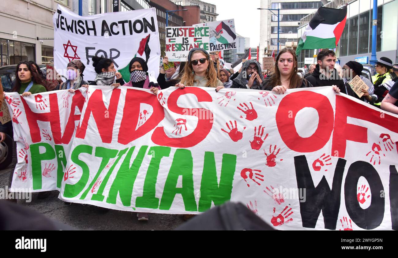 Pro-Palestine protest, led by women, in central Manchester, UK, 6th April, 2024. Marchers at the front of the protest carry a 'hands off Palestinian women' banner Stock Photo