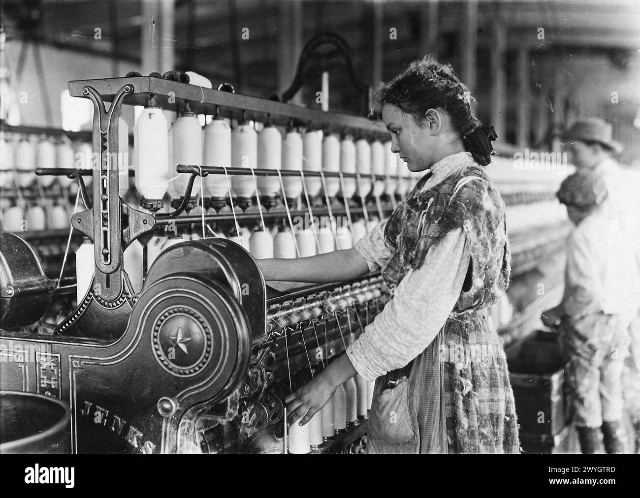 Young girl  Spinner in Vivian Cotton Mills. Been at it 2 years. Where will her good looks be in 10 years? Cherryville, North Carolina.  November 1908.   Vintage American Photography 1910s. Child Labour Project.  Credit: Lewis Hines Stock Photo