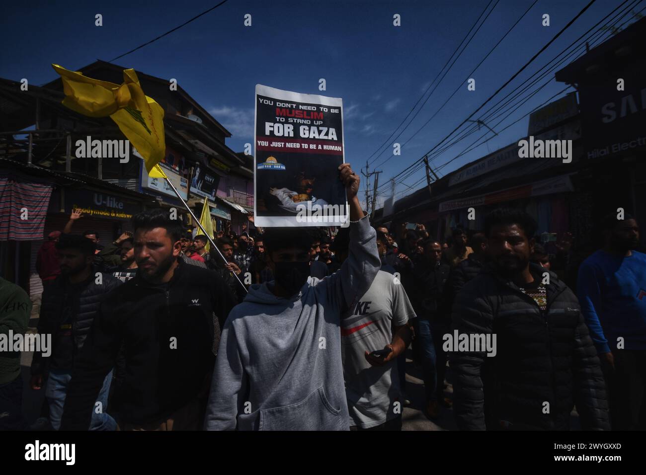 Kashmiri Shiite Muslim boy holds placard as he chant slogans against ...