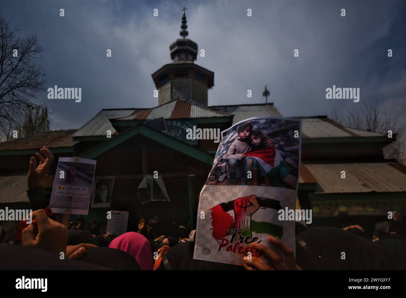 Kashmiri Shiite Muslim women hold banners and placards as they chant ...