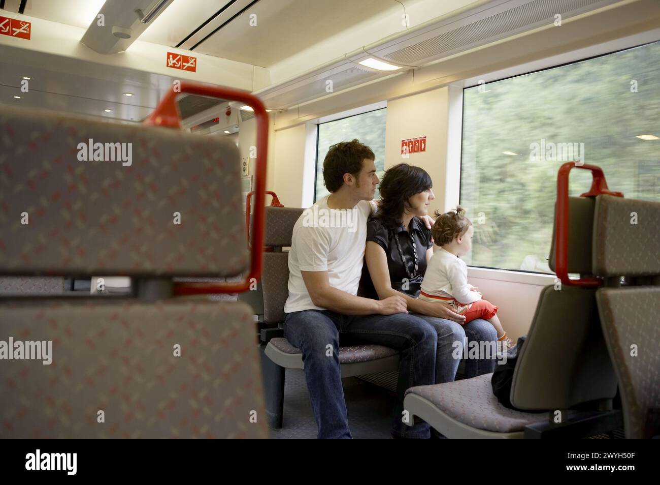 Family travelling in tramway Stock Photo - Alamy