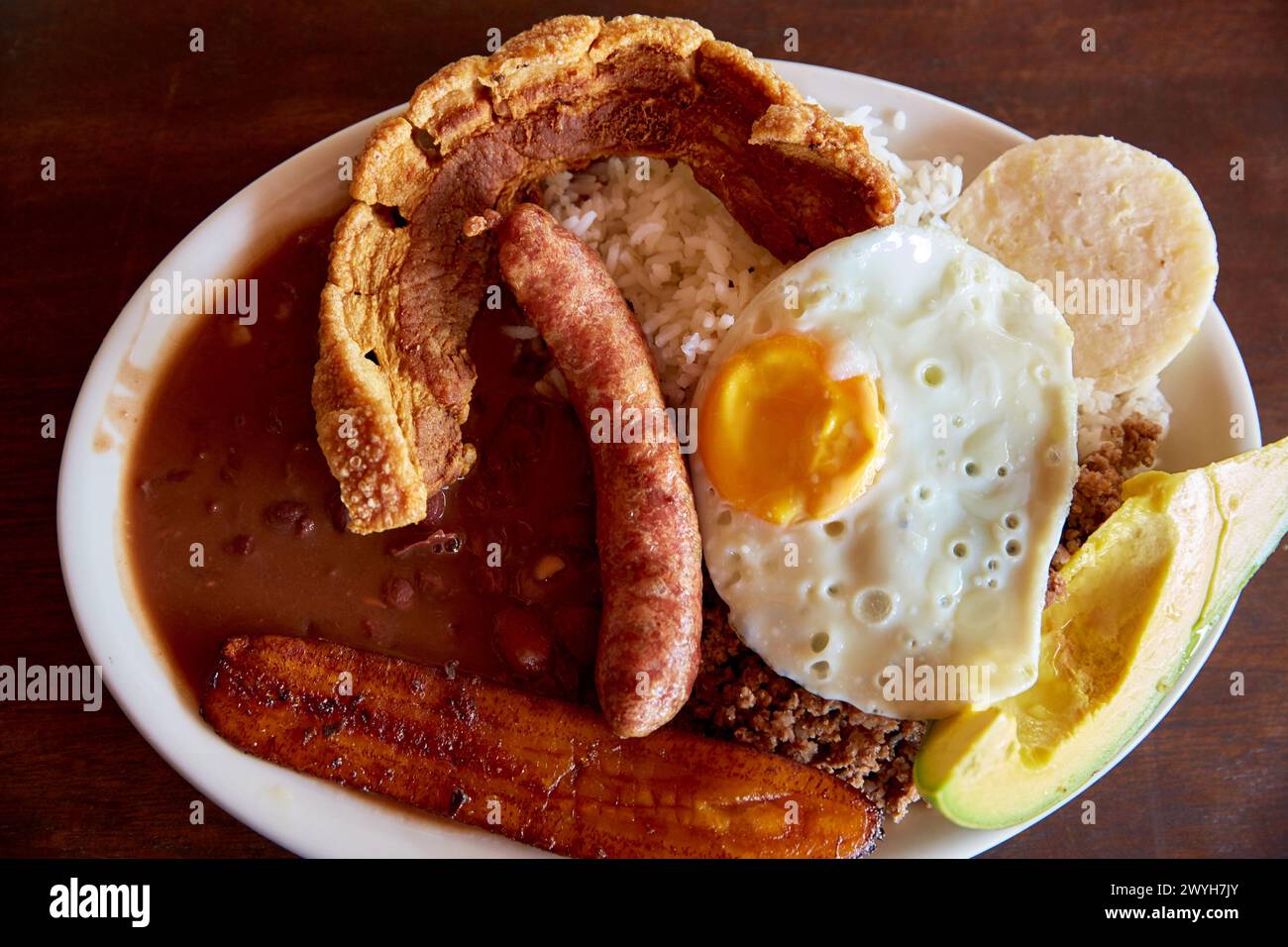 Bandeja paisa, Paisa tray (Ingredients: beans, rice, ground beef, sausage, pork, fried plantains, avocado, corn cake), It is typical of the Antiochian kitchen, most representative dish of the region, Antioquia, Colombia, South America. Stock Photo