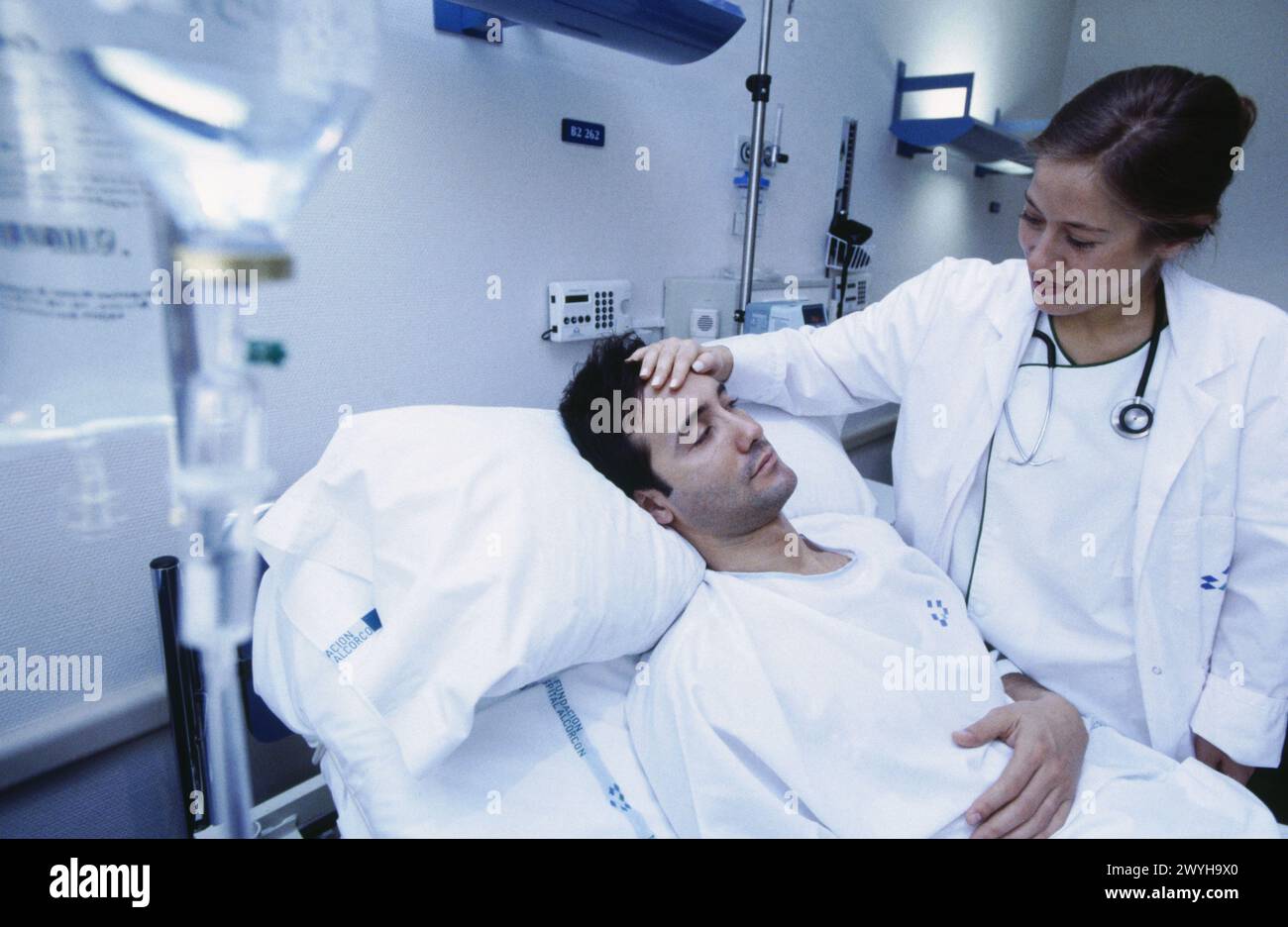 Doctor checking patients temperature hi-res stock photography and ...