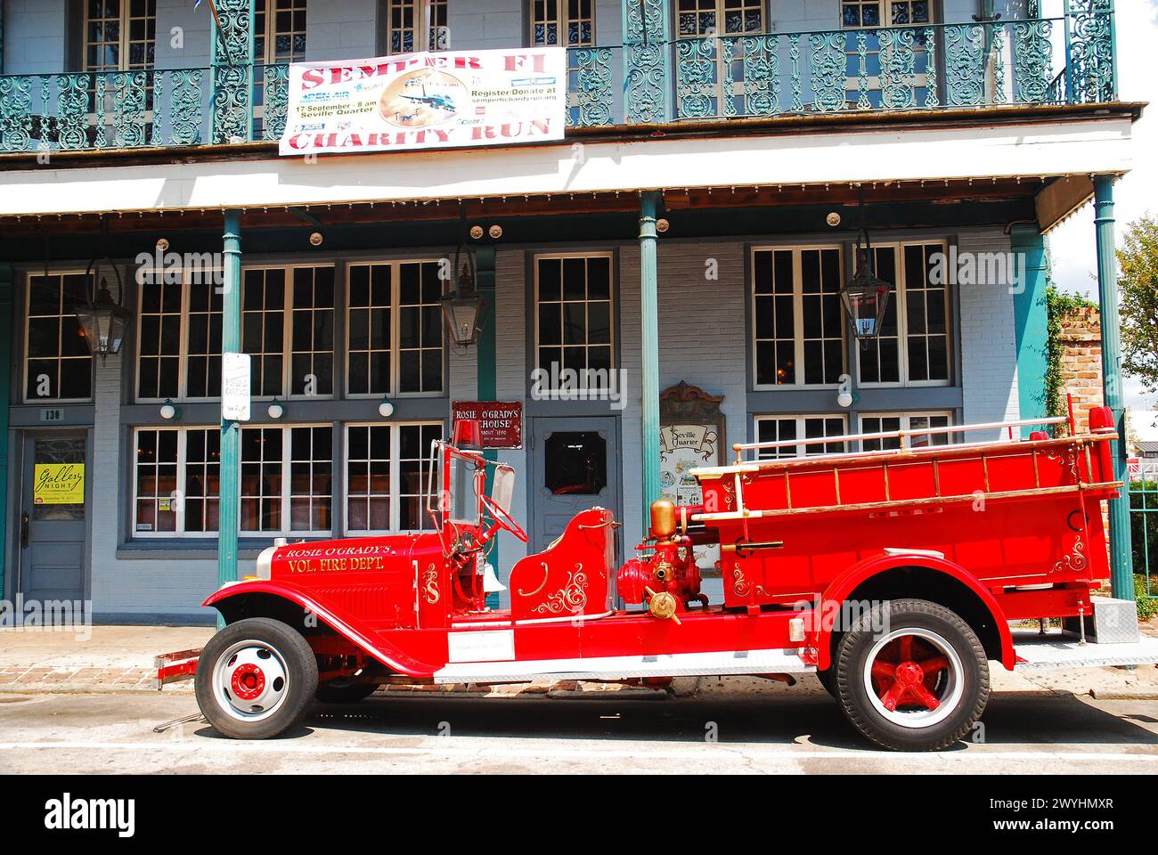 An antique Fire Truck in is parked in front of a pub in Pensacola's Historic Seville Quarter Stock Photo