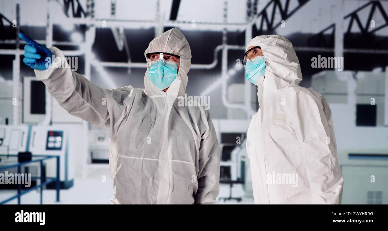 Sterile Semiconductor Manufacturing Factory And Workers In Coveralls Stock Photo