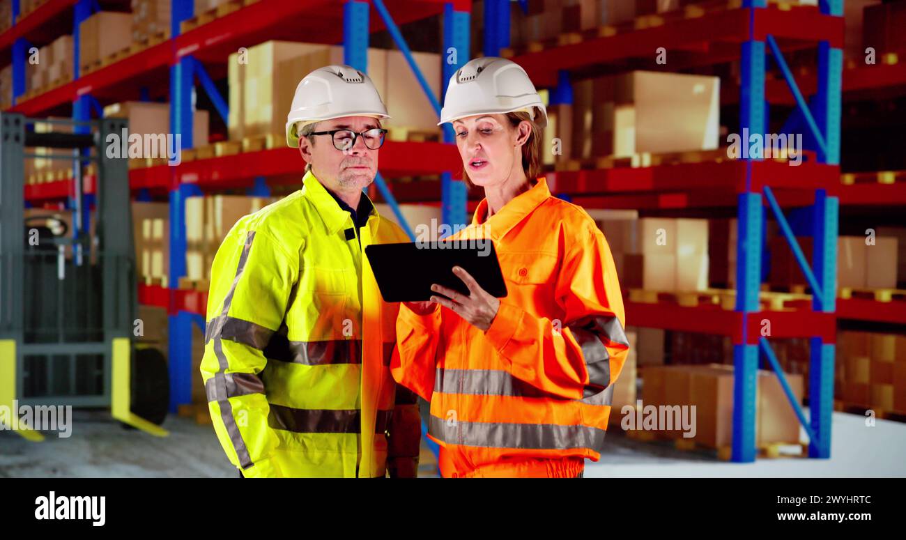 Osha Inspection Using Tablet. Inspecting Warehouse Inventory Stock Photo