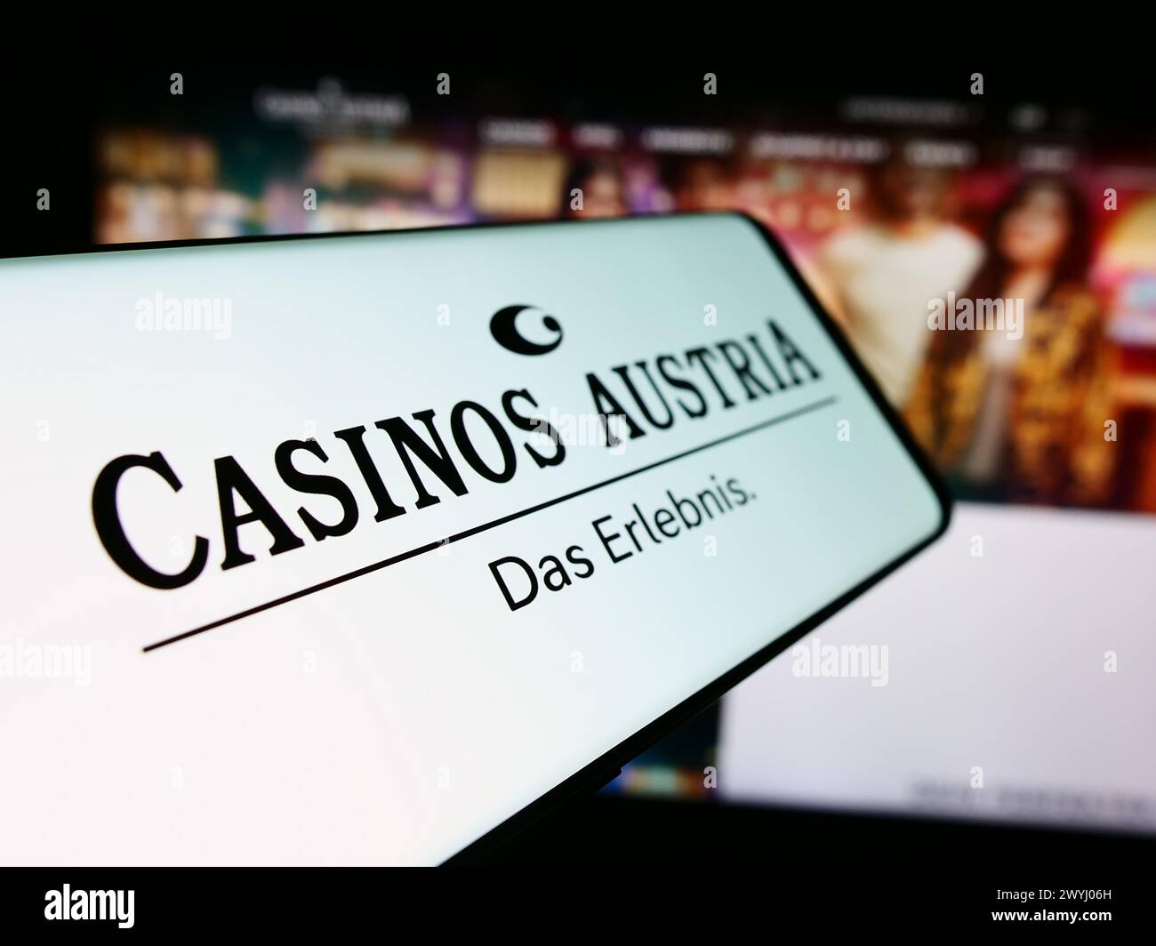 Mobile phone with logo of Austrian gambling company Casinos Austria AG in front of business website. Focus on center-left of phone display. Stock Photo