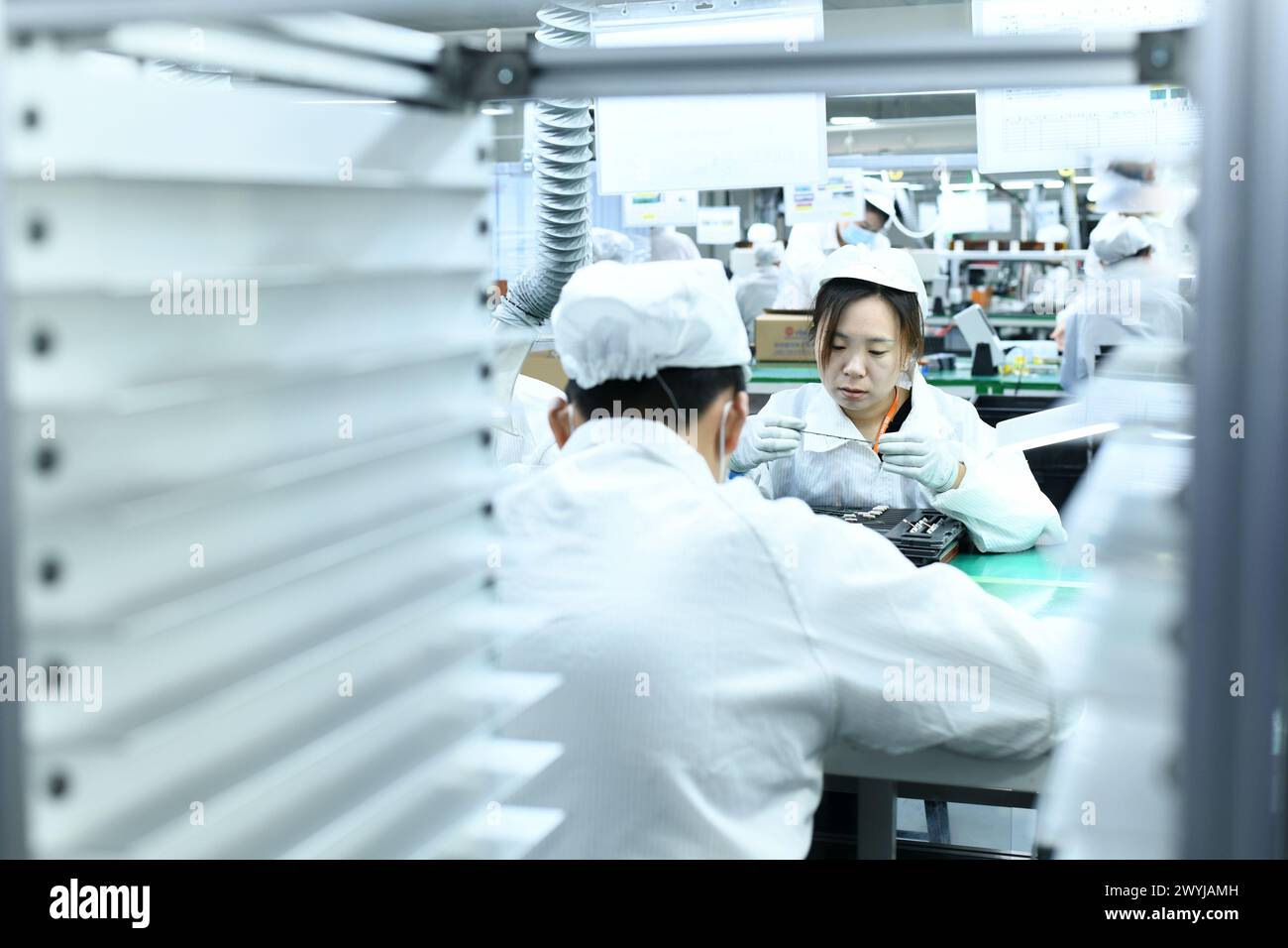 HAIAN, CHINA APRIL 7, 2024 A skilled worker is producing consumer