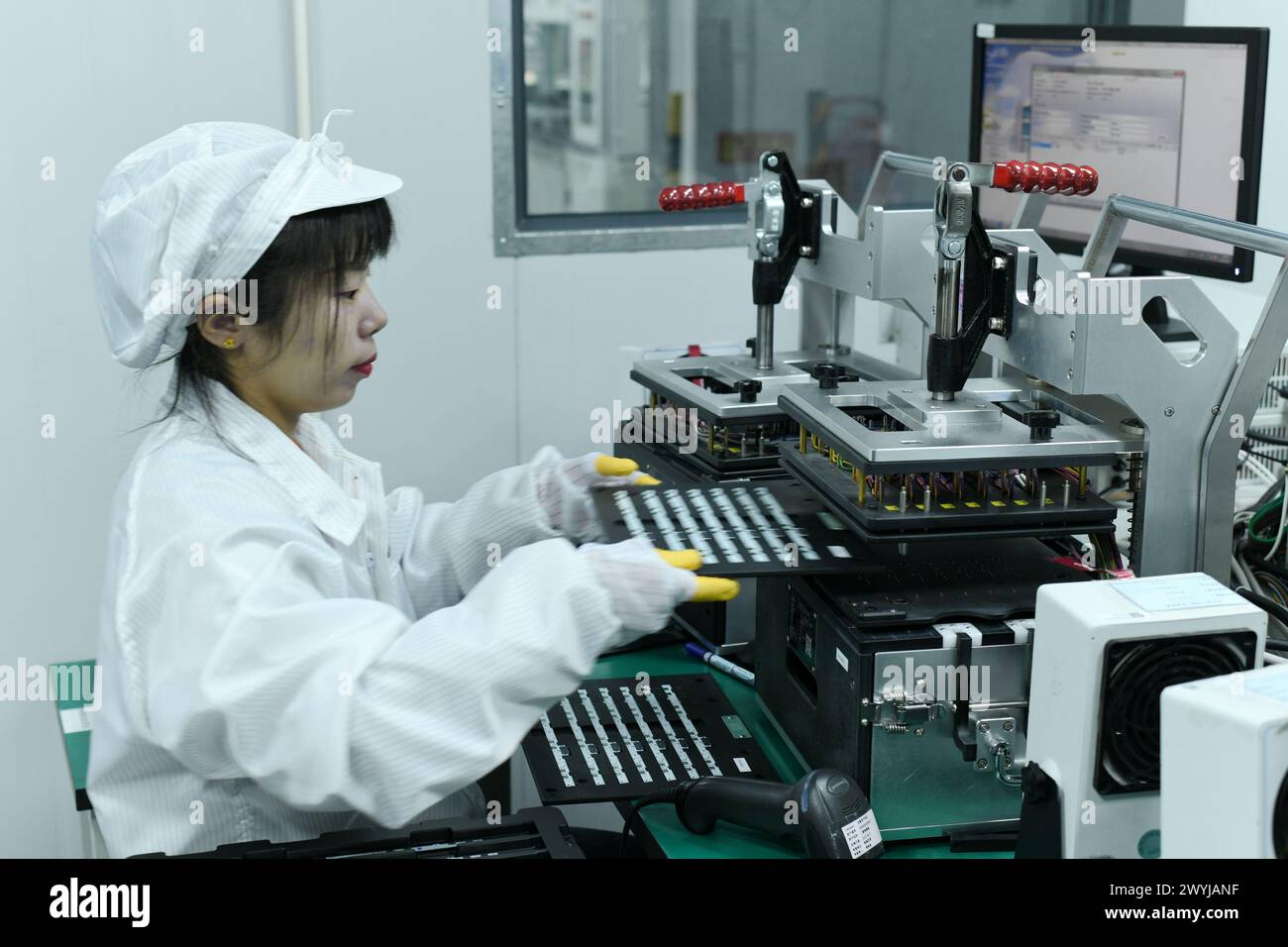 HAIAN, CHINA APRIL 7, 2024 A skilled worker is producing consumer