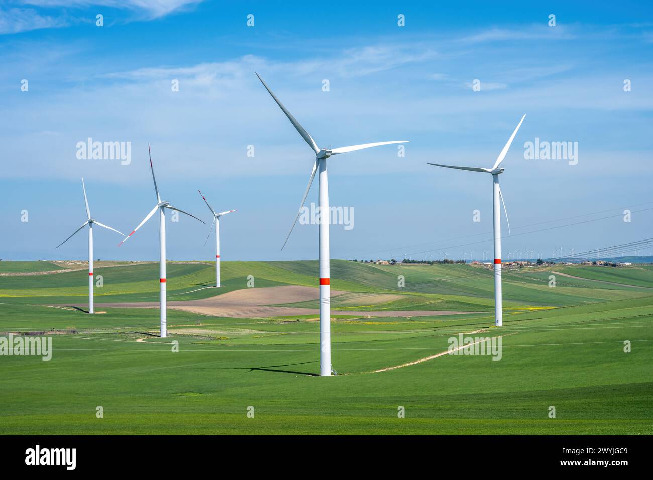 Wind turbines and green meadows seen in Italy Stock Photo