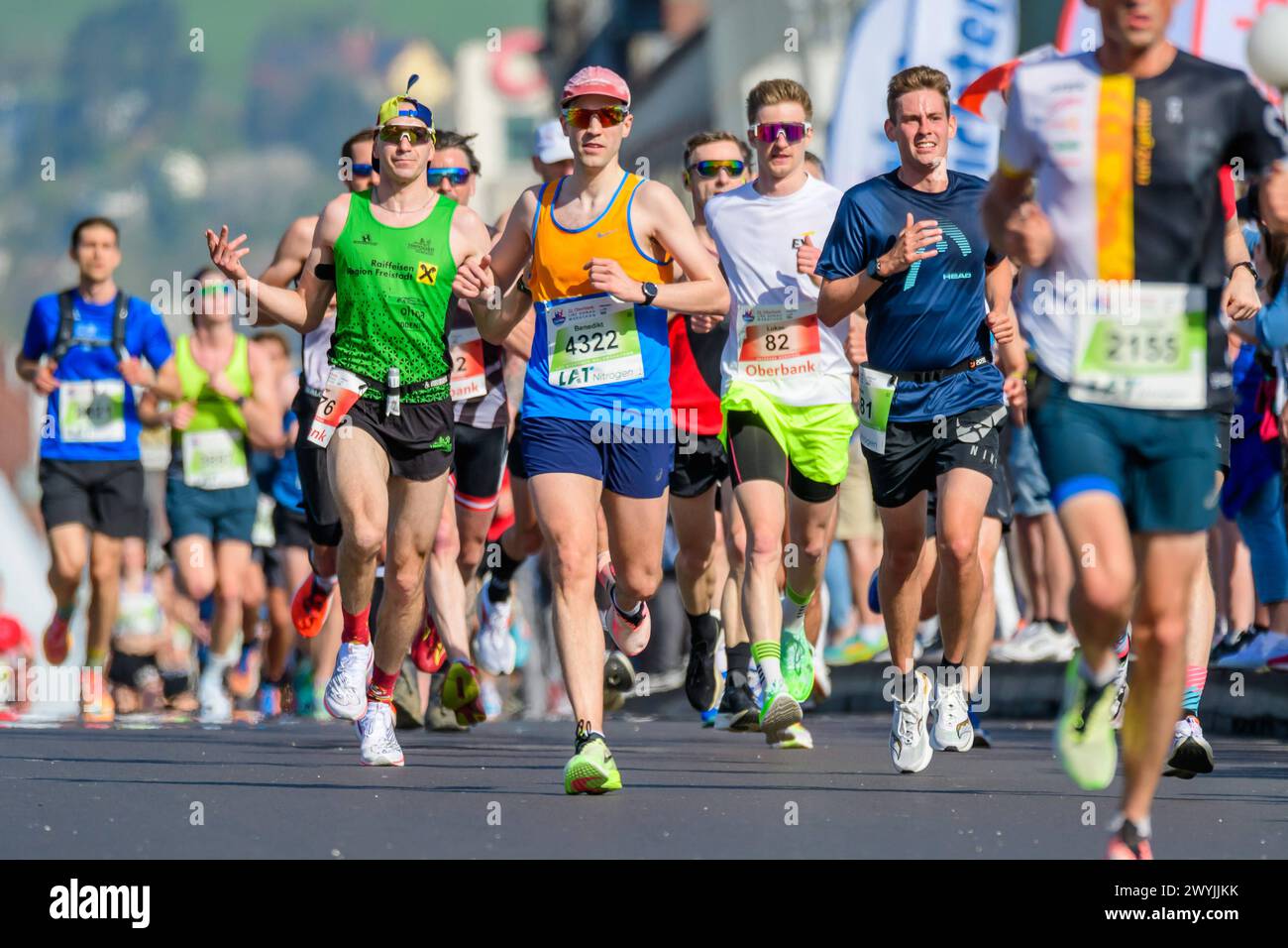 linz, austria, 07 april 2024, competitors of the linz marathon crossing