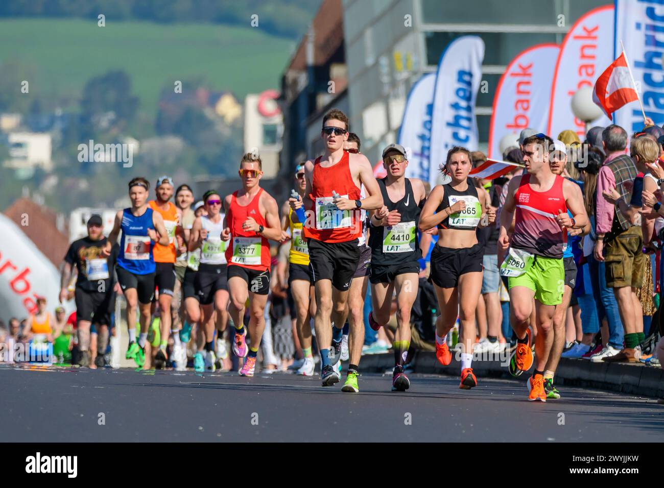 linz, austria, 07 april 2025, competitors of the linz marathon crossing
